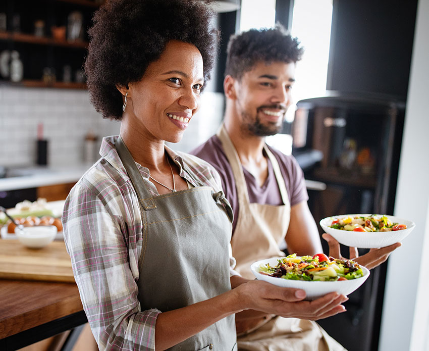 Couple holding plates in the kitchen