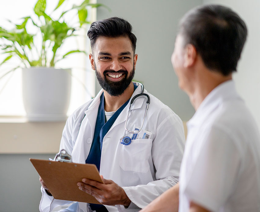 Male doctor smiling toward patient