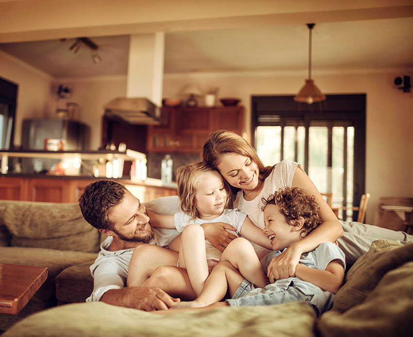Family hugging together on the couch