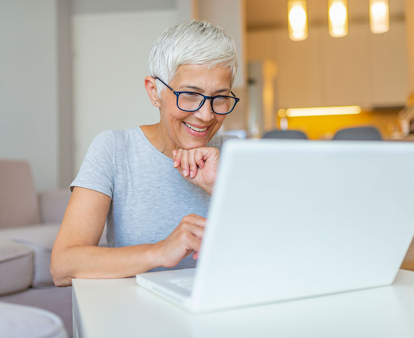 Older woman looking at her laptop