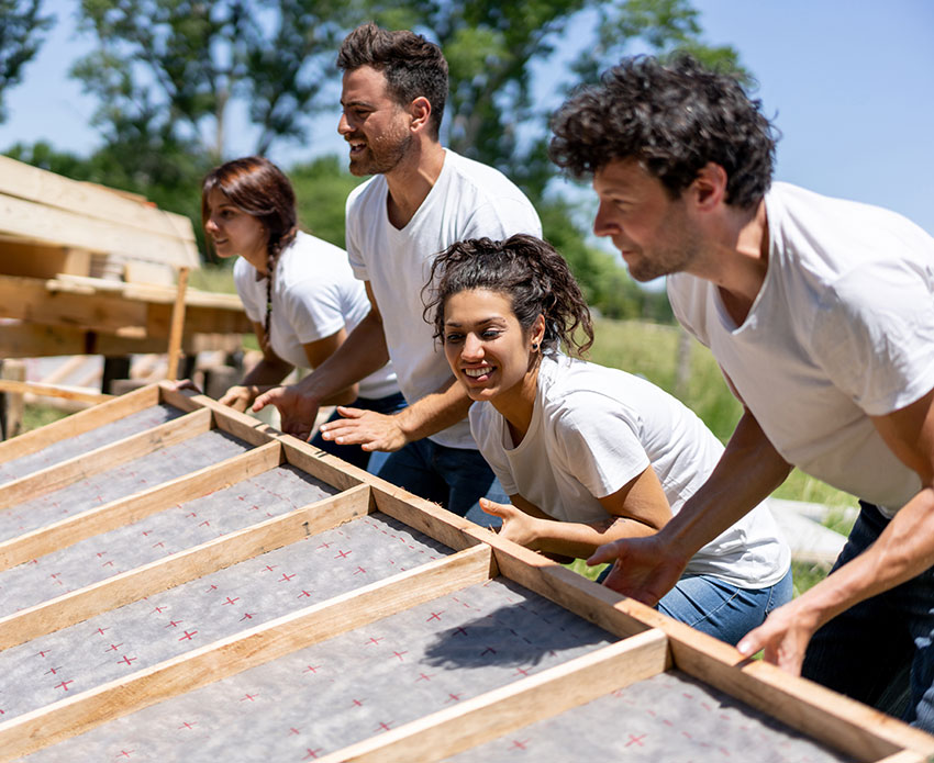 Team helping build house together