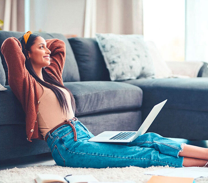 Woman with laptop looking relieved