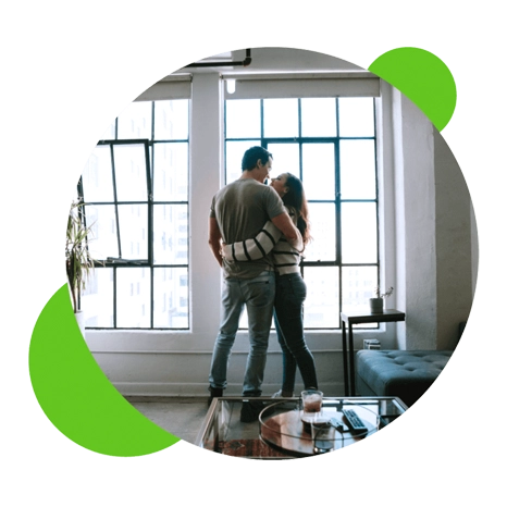 Couple embracing together in living room