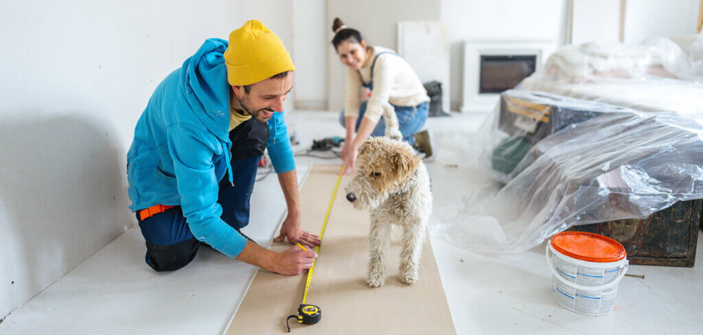 Young couple and their dog doing home renovations